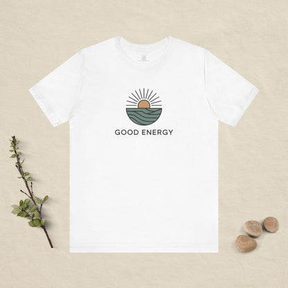 White t-shirt with 'Good Energy' design on a beige background