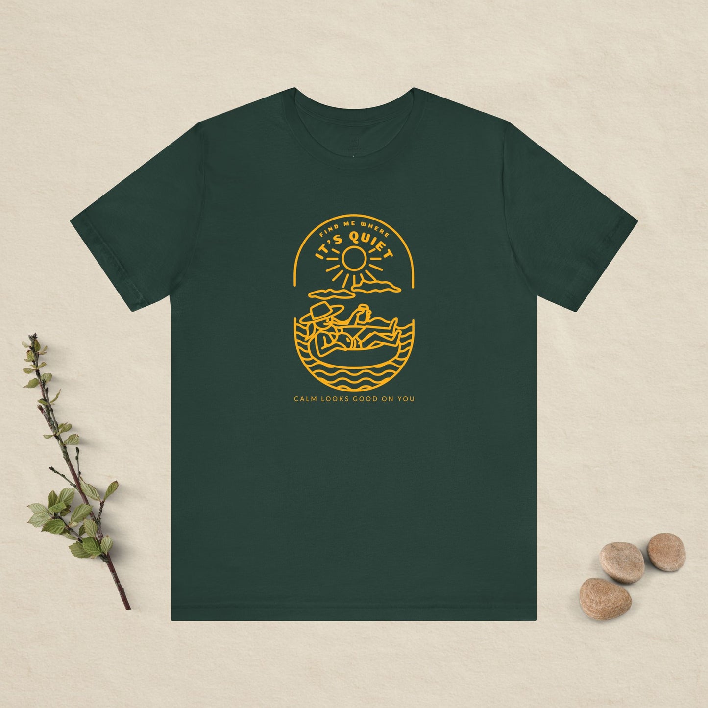 Green t-shirt with yellow graphic design on a beige background