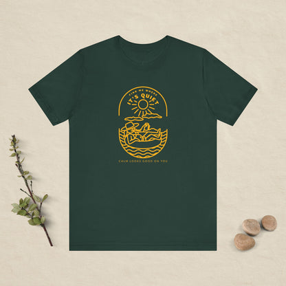 Green t-shirt with yellow graphic design on a beige background